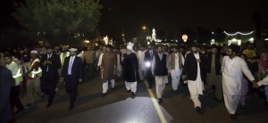 His Holiness walking through the streets of Peace Village at night. Residents rushed out to take a glimpse of His Holiness