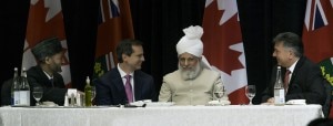 Charles Sousa, Ontario's Minister of Citizenship and Immigration to the left of His Holiness. On the immediate right of His Holiness is Dalton McGuinty, Premier of Ontario, and to the far right is Lal Khan Malik, National Amir (President) of the Ahmadiyya Muslim Community of Canada
