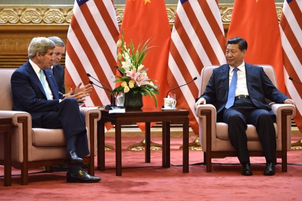 U.S. Secretary of State John Kerry speaks with Chinese President Xi Jinping. Tensions are rising between the two nations as China warns U.S. it could spark war due to provocative acts in South China Sea. (accessed via Wiki Commons).