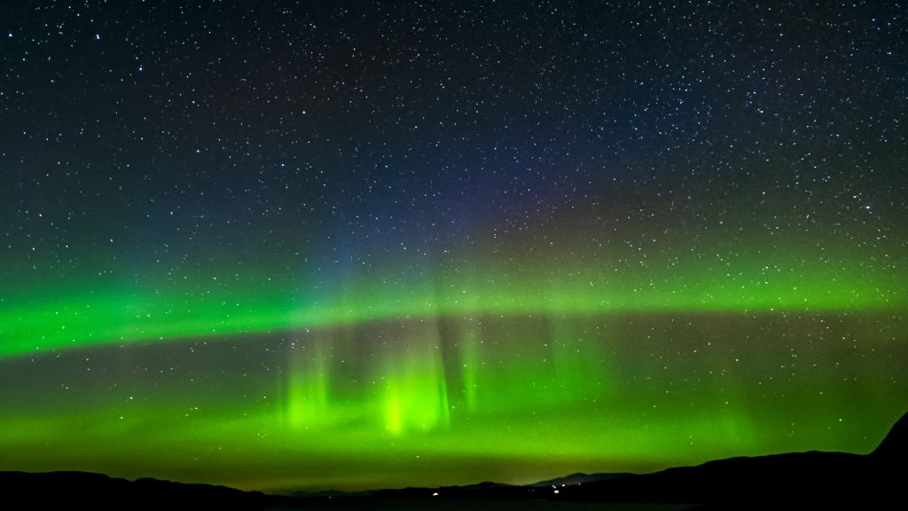 The Northern Lights (Aurora Borealis) seen over the Isle of Skye, Scotland.